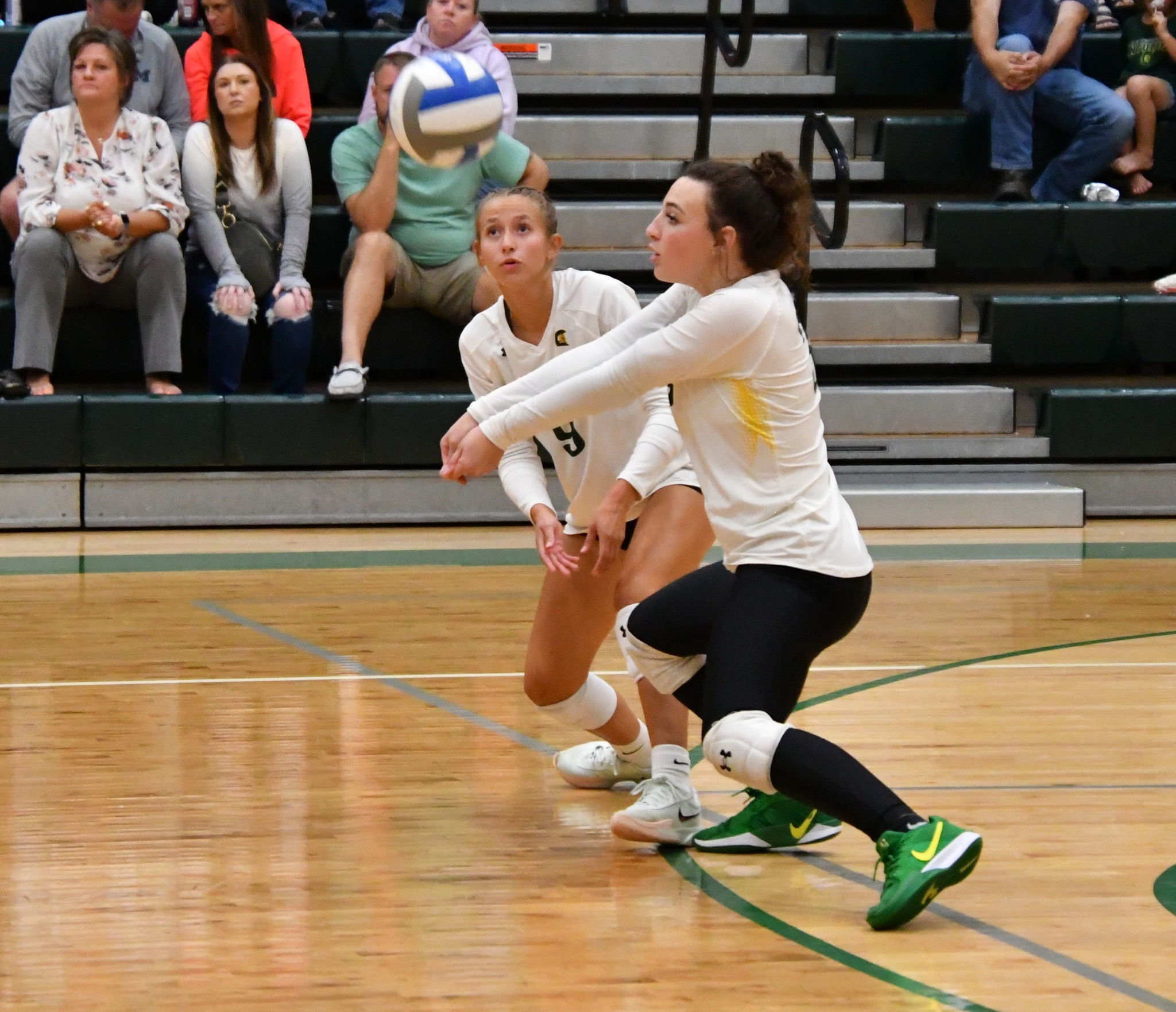 MCC Volleyball player bumps the ball on the court.