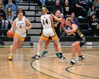 MCC women's basketball player Emily Putnam dribbles with her right hand and takes advantage of a screen set by her teammate to get open.