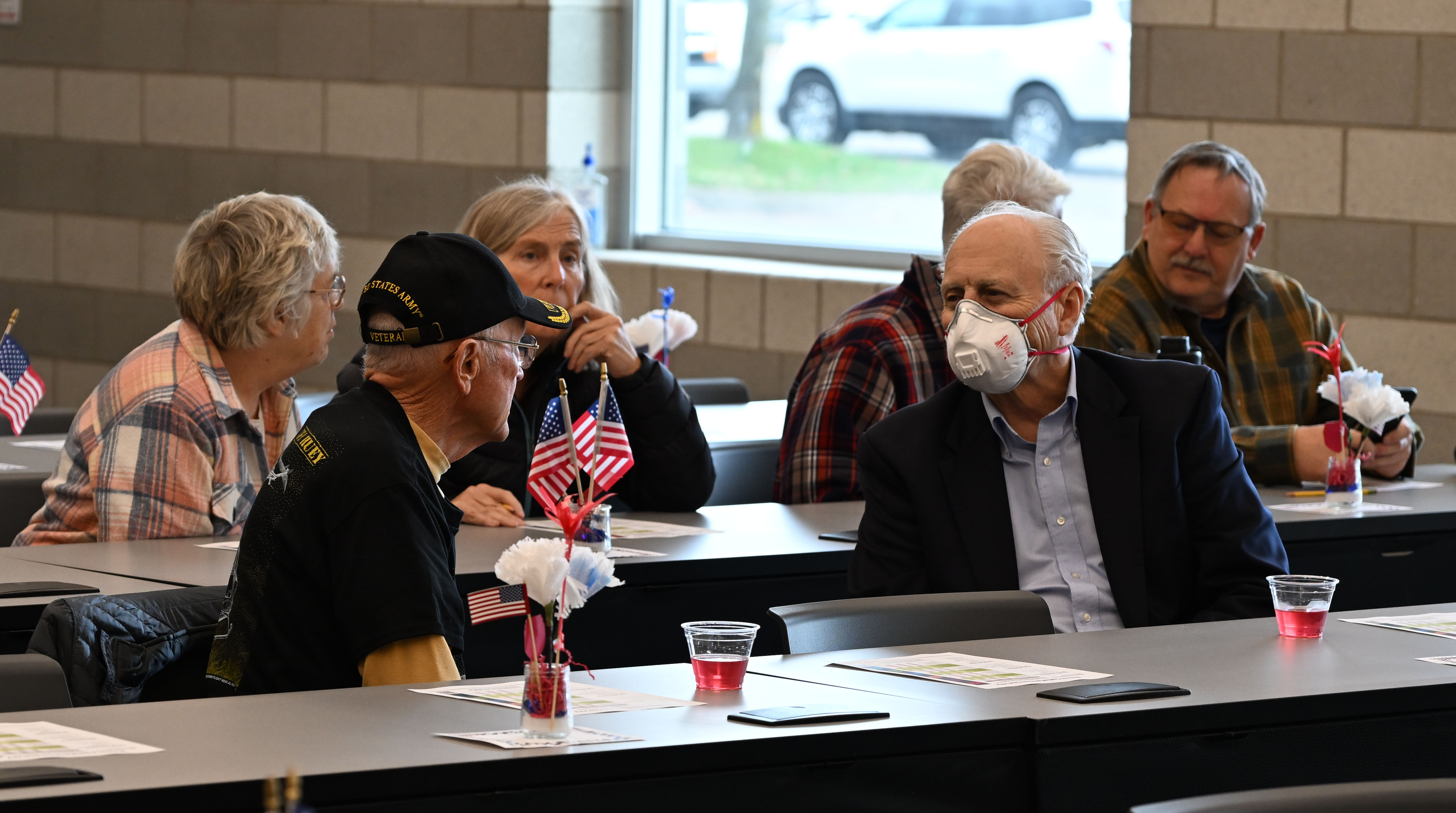 A group of people sitting at tables during the 2024 Veterans Day event on the Greenville campus.