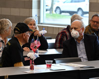 A group of people sitting at tables during the 2024 Veterans Day event on the Greenville campus.