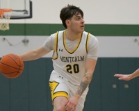 MCC basketball player Geronimo Mozzi dribbles the ball with his right hand while looking to his left.
