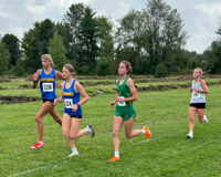 MCC cross country runner Annette Fare runs in a pack alongside three runners from other schools during a meet.
