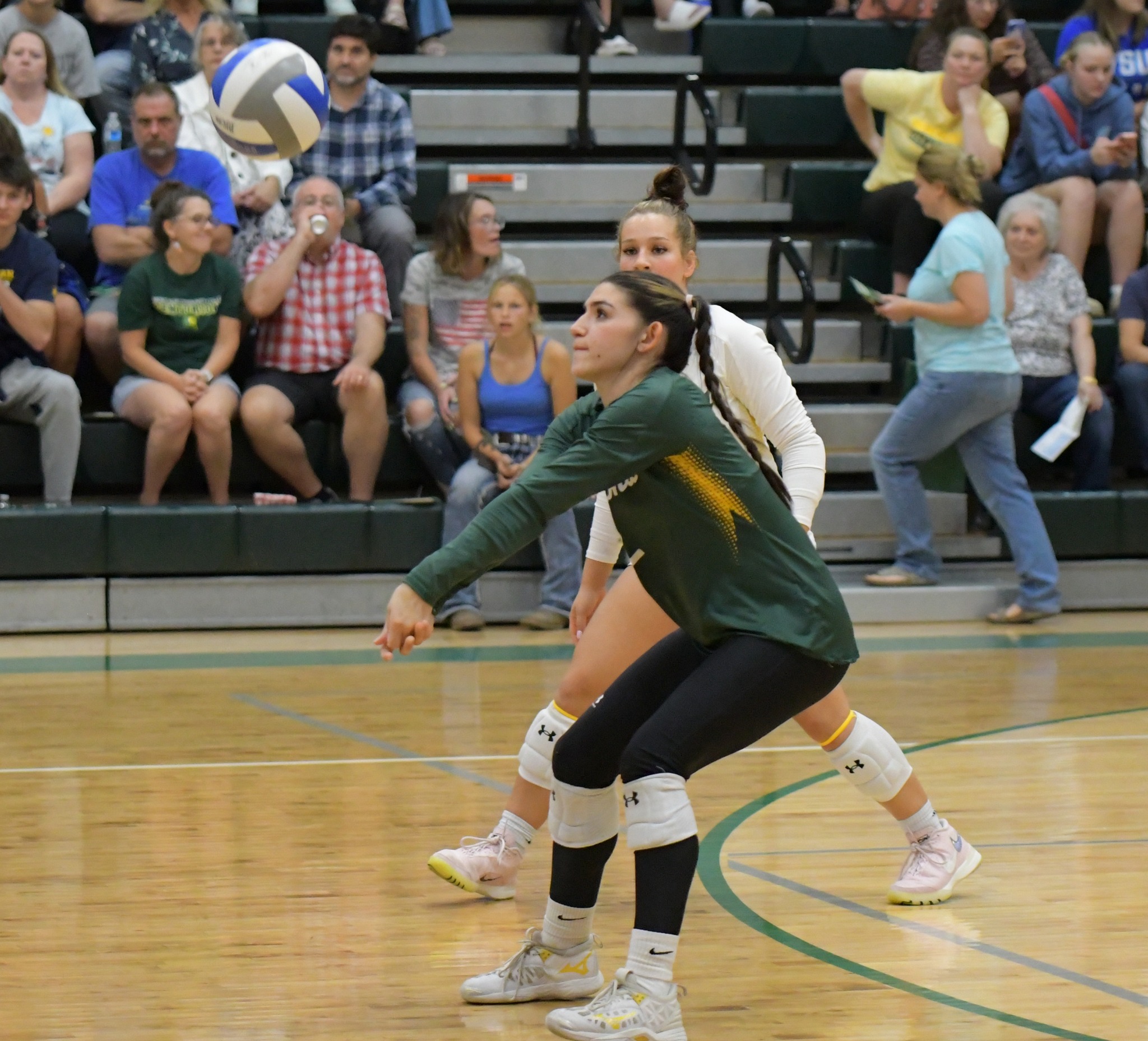 MCC Volleyball player Jaden Gomez bumping the ball during a match.