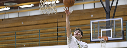 Men's basketball player Trevor Zamarron shooting a layup during practice.