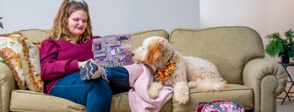 Picture of girl and her dog on the couch.