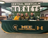 Emily Putnam poses for a picture with her family during her athletic signing with MCC.