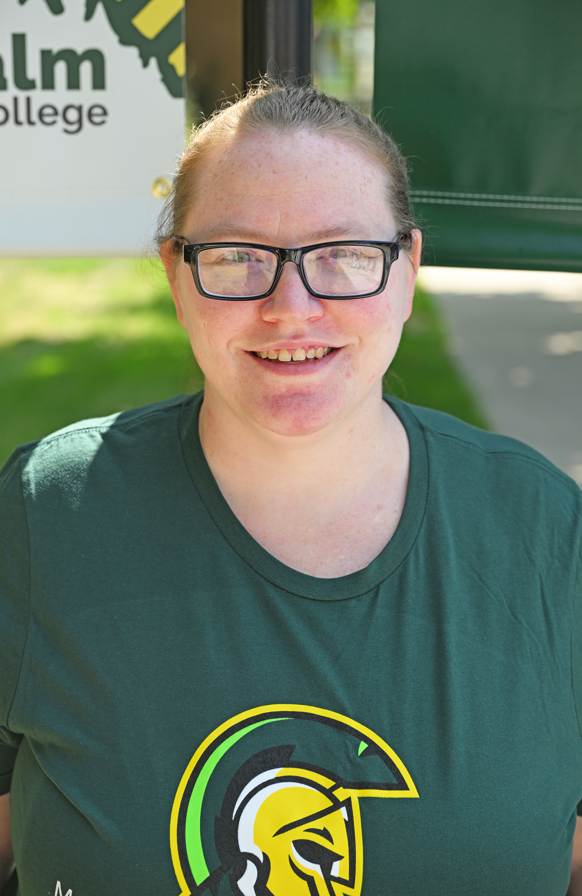 Headshot of Nina Easey wearing a green shirt with the Centurion logo on it.