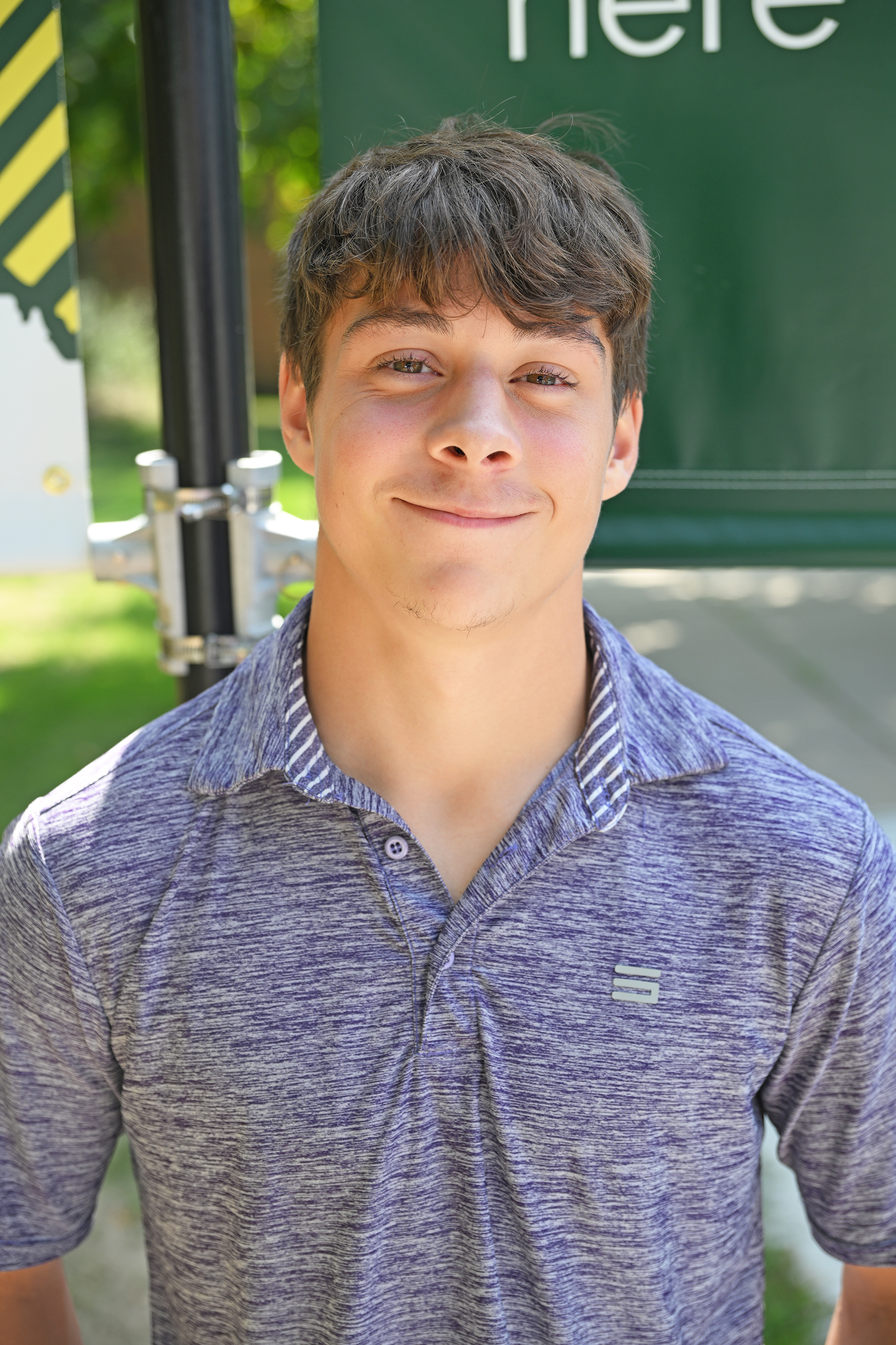 Headshot of Logan Codling wearing a gray polo shirt.