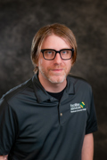 Professional headshot of MCC Custodian Dustin Hausserman.