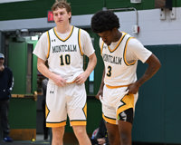 MCC men's basketball players Andrew Badder and Dorian Allen stand next to each other while adjusting their jerseys.