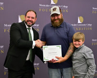 Photo of Bradley Barrick giving Greg Olmstead certificate