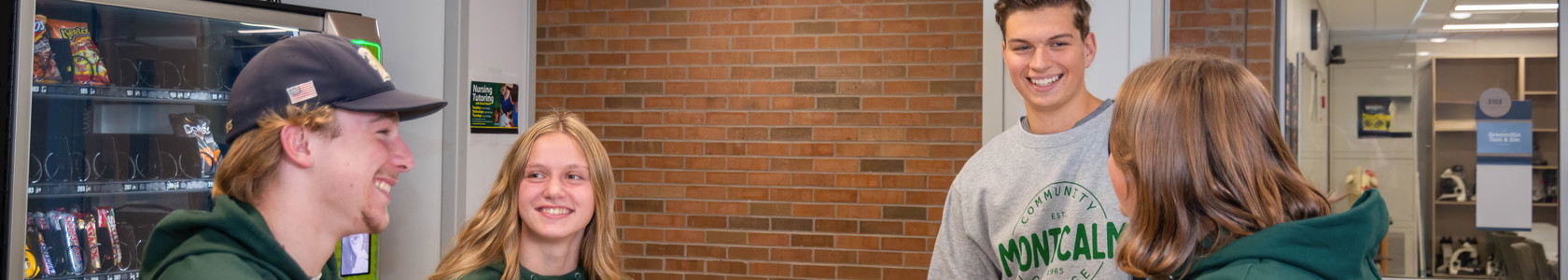 Photo of MCC Students smiling around a table.