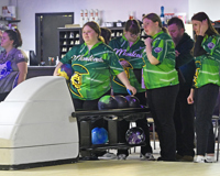 Members of the MCC women's bowling team are shown warming up prior to the start of a match.