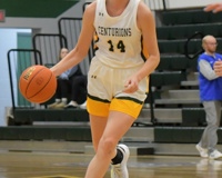 MCC women's basketball player Makenna Rautio dribbles the ball with her right hand while running up the court.
